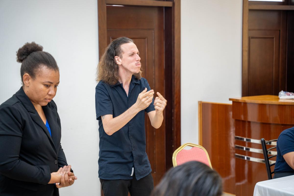 Mr. Calvin Morel signing during the group discussion